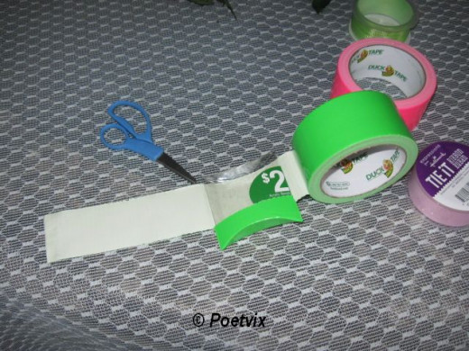 Cover the sides of the purse in duct tape by laying it on the sticky side of the tape and rolling it