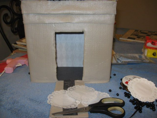 Cover the drawbridge. I ran a scrap from some of the paper I used inside to make a kind of path way here.