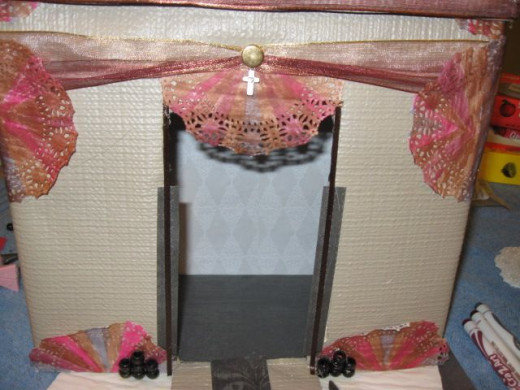 Add some ribbon across the top, a stud and a cross charm.