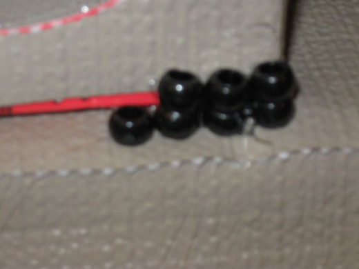 Pony beads stacked make the "stones" at the bottom.