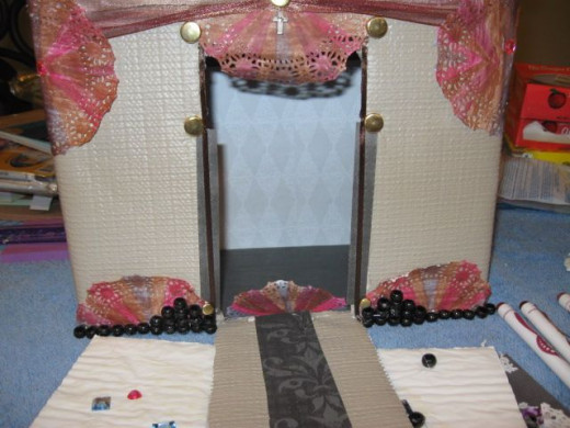 Paper, ribbon and studs trim out the draw bridge entry way.