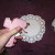 Lay the larger doilies on the work surface. Apply a good bit of glue to the center part.