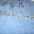 When all of your top chain of pop tabs are connected, bend the wire over and snip off any ends that are sticking up. If you feel any sharp points anywhere, cover them with a drop or two of hot glue and let dry before continuing. It only takes a minut When all of your top chain of pop tabs are connected, bend the wire over and snip off any ends that are sticking up. If you feel any sharp points anywhere, cover them with a drop or two of hot glue and let dry before continuing. It only takes a minut