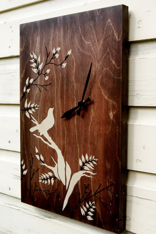 This pretty clock has a stencilled and embroidered bird design on the ...