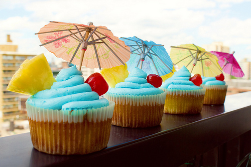 That's a vanilla, coconut & rum cupcake with pineapple jelly inside and a bright blue Curaçao buttercream icing on top!
