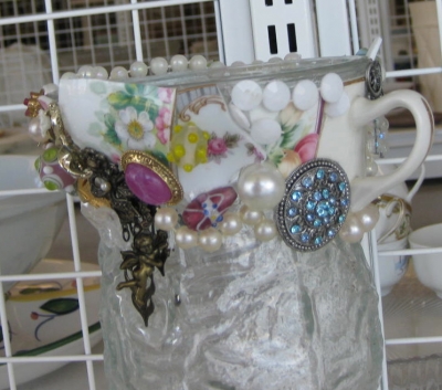 Costume Jewelry and Mosaic China on a Glass Vase