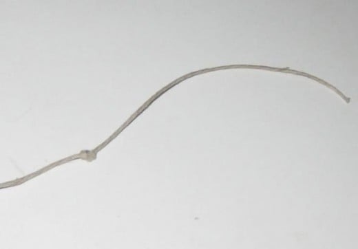 Tie a knot near the top of the cord, about 3 or 4 inches from the top.