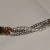 Sweater guard with three strands: chain and pearls. Sweater guard with three strands: chain and pearls.