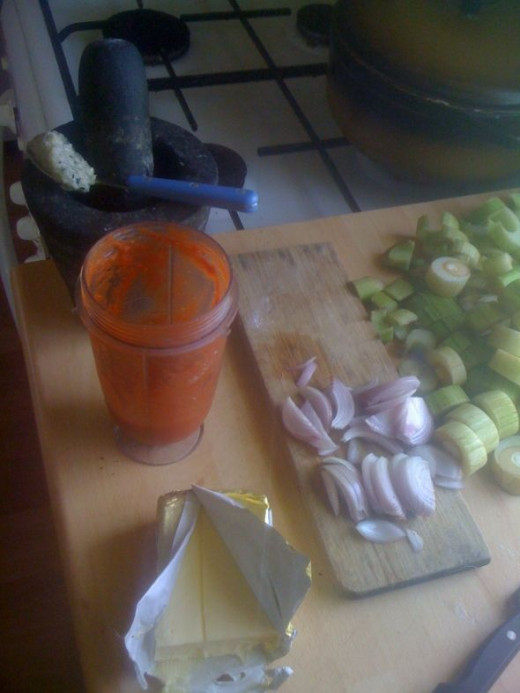 Assemble all ingredients - slice the onions, heat up a heavy bottomed pot and open the tomato puree.