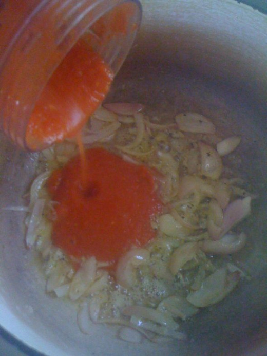 Add the tomato puree.
