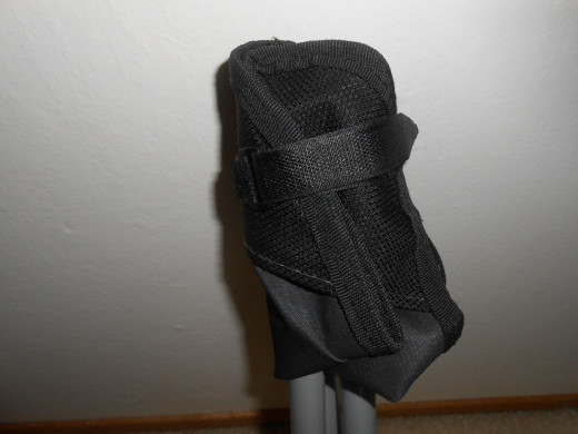 A velcro strap around seat keeps the chair legs secure for carrying.