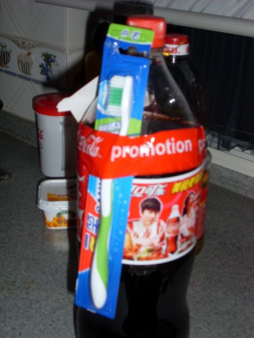 A bottle of coke with a toothbrush as a free gift.