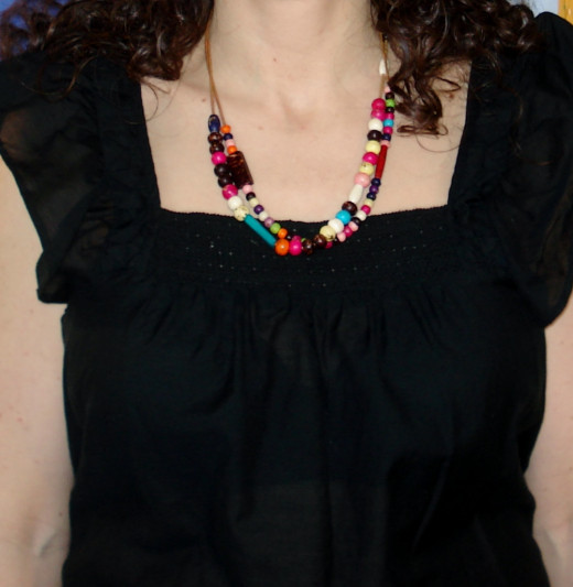 A 16-18 inch necklace can bring lead the eye up and away from noticing large breasts.