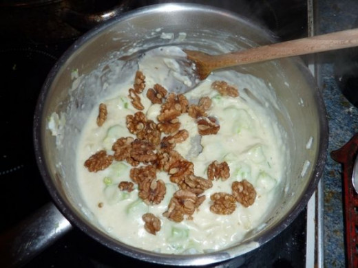 Adding the walnuts to walnut and broccoli soup