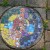 Here is yet another attractive plaque set into the crazy paving. It gives a real Gaudi feel to the grotto which we love! These mosaics were produced by a group of artists with learning difficulties. The group is run by Phil Robinson and the artists n