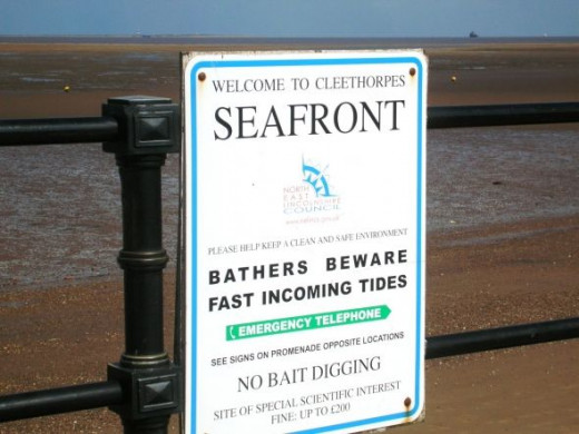 The notice here warns against bait digging and faster tides. Bait digging is a problem because the holes interfere with the integrity of beach sand. They tend to silt up and produce sinking sand. For this reason digging is confined to speific areas.