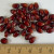 Kernels of a red, pearl-style corn marketed under the US trademark "Crimson Jewell" by the Black Jewell Popcorn co.