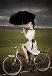 Woman on a bike with parasol