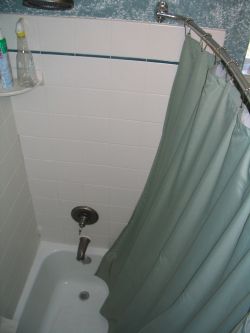 The shower curtain bows away from your body, giving you more room