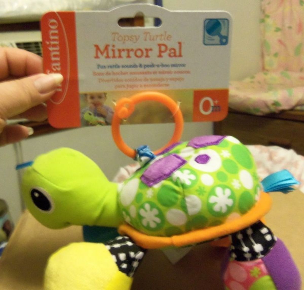 You can see how colorful this little guy is. His legs are soft and floppy with a crunchy sound when you squeeze them.  On the underside of the turtle is a mirror, so when it is hanging above the baby he/she can see their reflection.