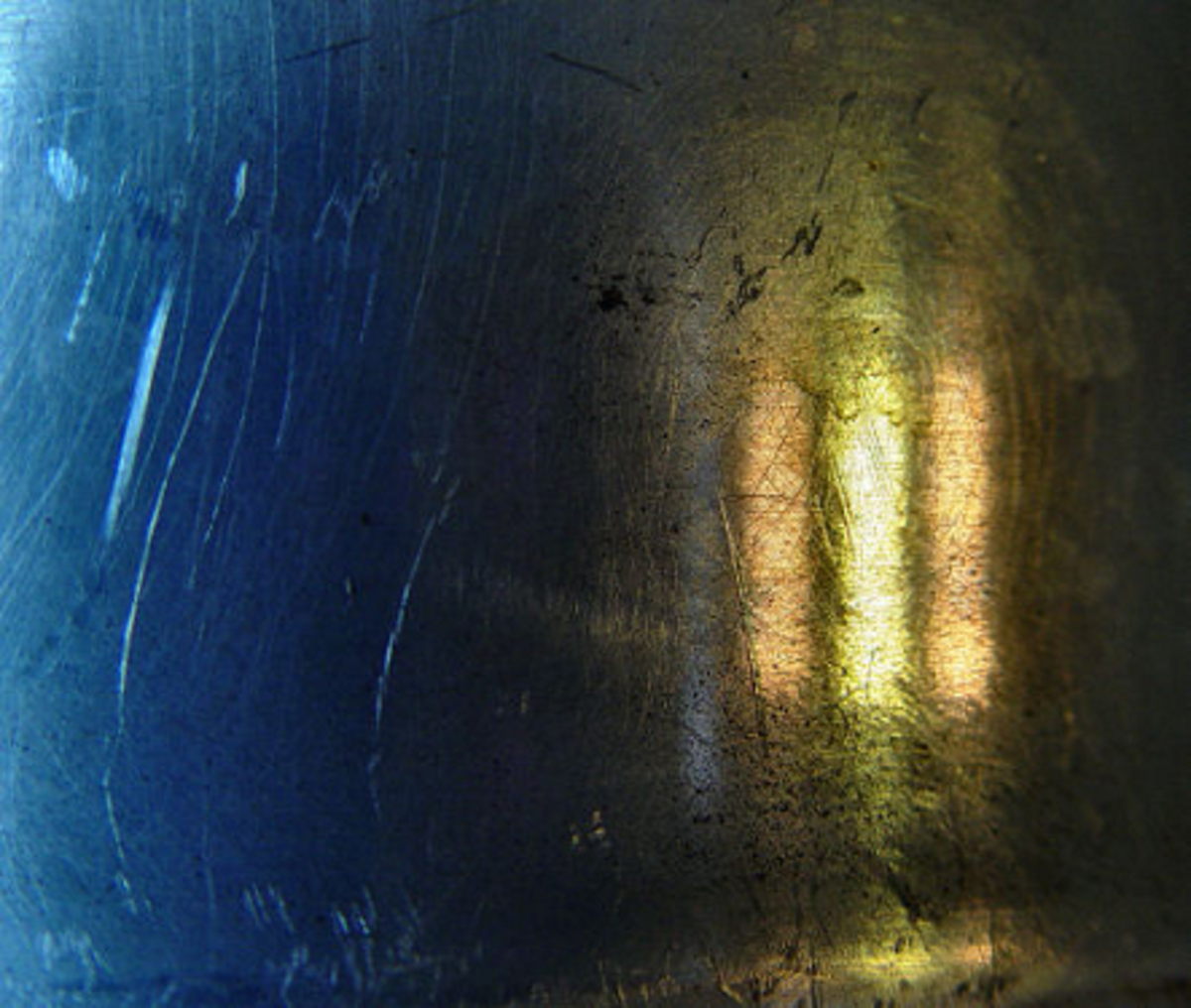 Reflection of a lamp in old metal kettle