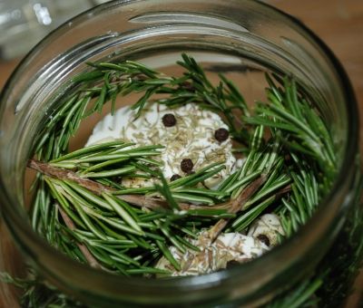 Top your layers of cheese with herbs and peppercorns.