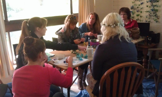 Friends and family chatting and working around the craft table at one of our crafternoons. 