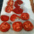 Thinly siiced tomatoes draining on a paper towel Thinly siiced tomatoes draining on a paper towel