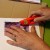 Carefully cut a slit above the head of the person. Be sure to put cardboard or a cutting mat under the photo. Carefully cut a slit above the head of the person. Be sure to put cardboard or a cutting mat under the photo.